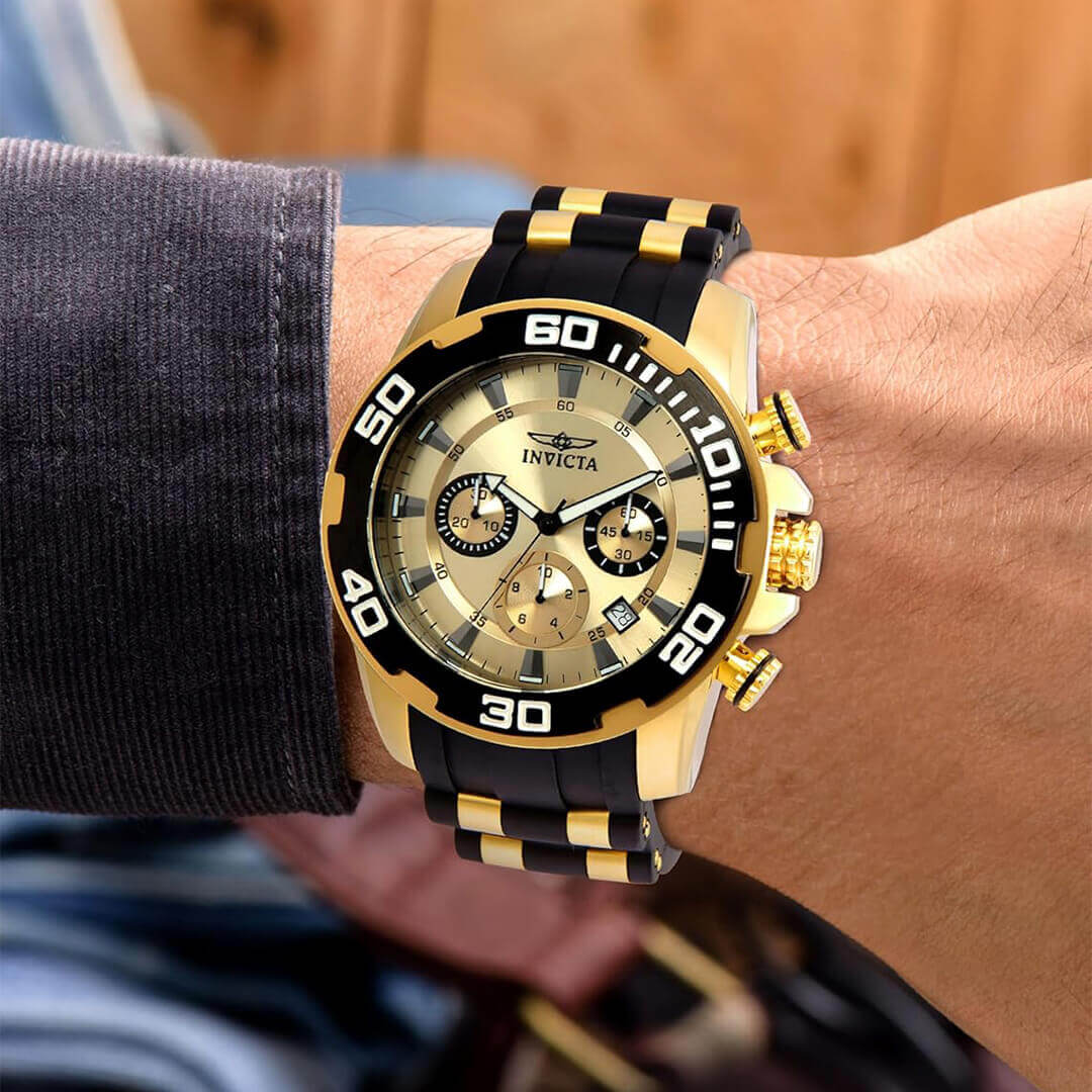 Invicta PRO DIVER SCUBA 22346 wristwatch, featuring gold-tone dial, black silicone strap, and sporty design.