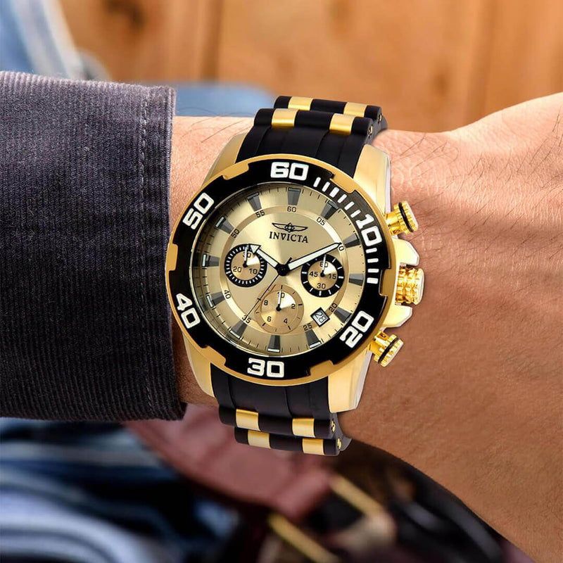 Invicta PRO DIVER SCUBA 22346 wristwatch, featuring gold-tone dial, black silicone strap, and sporty design.