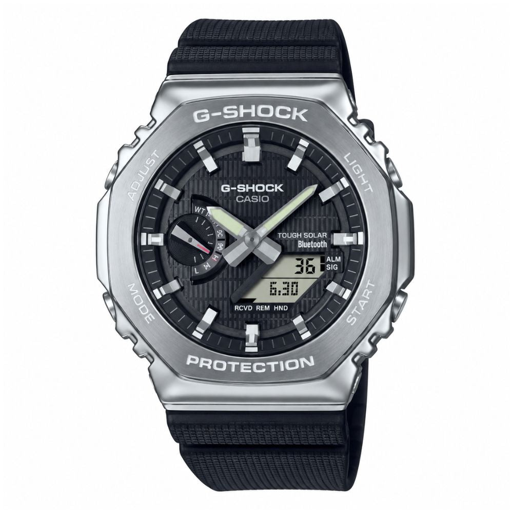 Reloj Casio G-SHOCK GBM-2100A-1A con esfera negra, bisel plateado y correa de resina negra, vista frontal.