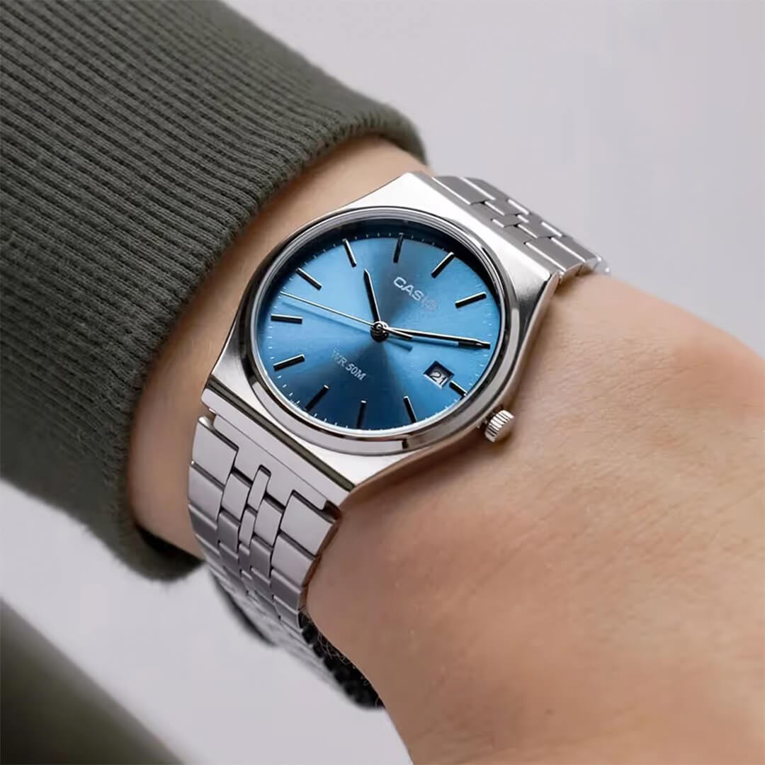 Reloj Casio MTP-B145D-2A2 en la muñeca, primer plano de la esfera azul
